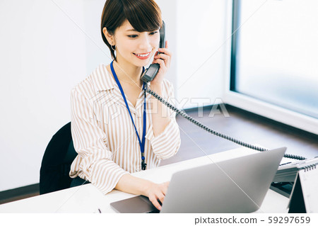 A woman who handles telephone calls 59297659