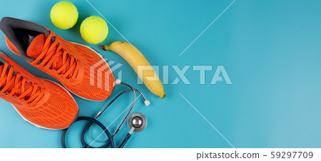 Orange sports shoes and stethoscope in healthcare concept. 59297709