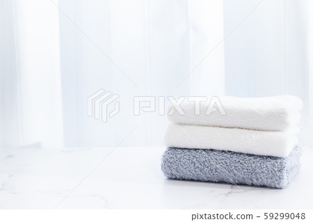 A towel washed in detergent and folded in the room. Image of housework. A towel washed in detergent and folded in the room. Image of housework. 59299048