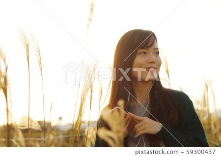 一個女人在Suki領域聽音樂時走路 一個女人在Suki領域聽音樂時走路 59300437