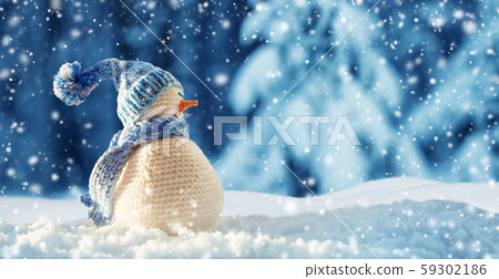 little snowman on soft snow on blue background 59302186