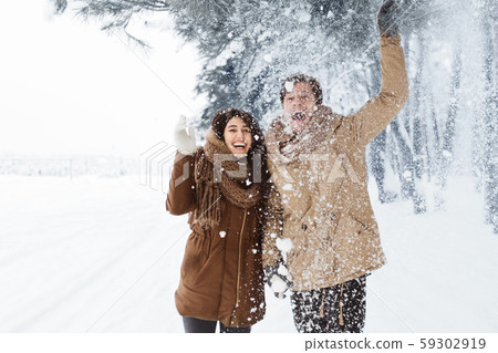 Happy Couple Throwing Snow Walking In Snowy Winter Forest Happy Couple Throwing Snow Walking In Snowy Winter Forest 59302919