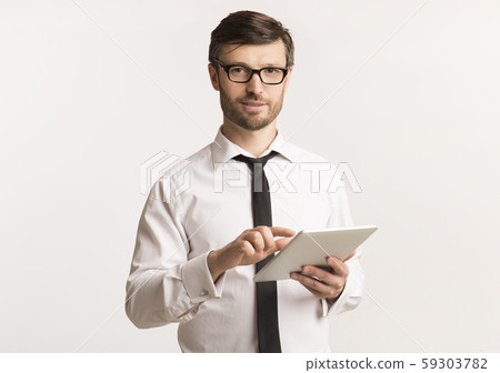 Businessman Using Tablet Computer Standing, Studio Shot 59303782