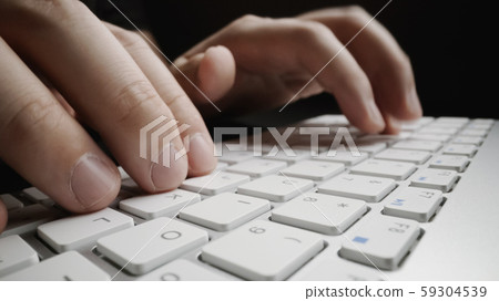 Close-up soft-focus finger typing on keyboard. Close-up soft-focus finger typing on keyboard. 59304539