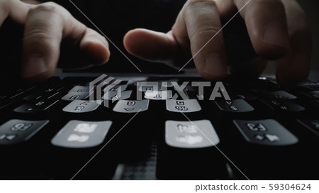 Close-up soft-focus finger typing on keyboard. 59304624