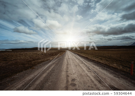 Empty dirt road through countryside landscape. Empty dirt road through countryside landscape. 59304644