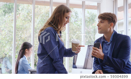 Businesswoman and businessman having conversation. Businesswoman and businessman having conversation. 59304899