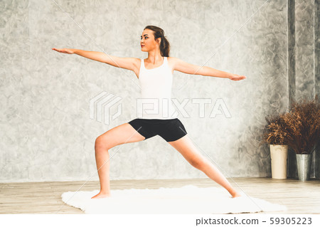 Young woman yoga on carpet at home living room. Young woman yoga on carpet at home living room. 59305223
