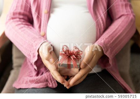 Happy pregnant woman and expecting baby at home. 59305715