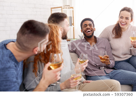 Home gatherings. Friends drinking wine and chatting 59307360