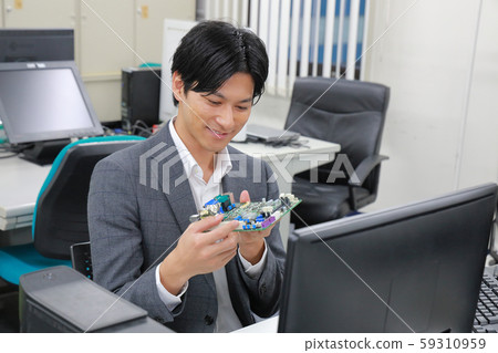 Engineer 1 inspecting the board with a smile 59310959