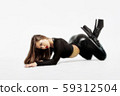 Attractive charming woman in leather suit and high 59312504