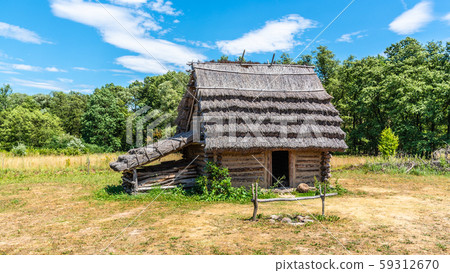 Small shepherd hut with straw roof on sunny day Small shepherd hut with straw roof on sunny day 59312670