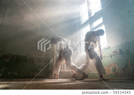 Two crazy men in straitjackets are in an abandoned clinic 59314345