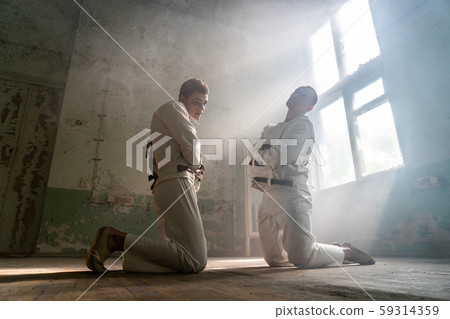 Two crazy men in straitjackets are in an abandoned clinic 59314359