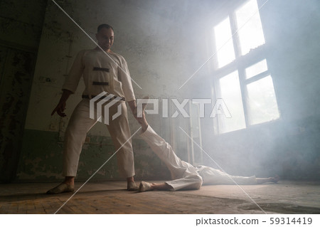 Two crazy men in straitjackets are in an abandoned clinic 59314419