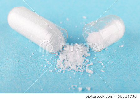 one open capsule of nutritional supplement msm, sulfur, on blue background one open capsule of nutritional supplement msm, sulfur, on blue background 59314736