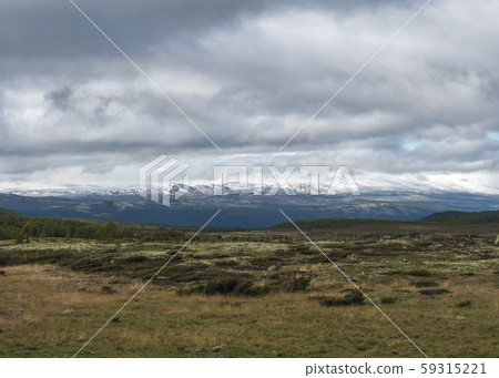 Autumn view on hills and snow capped mountains 59315221