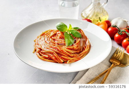 Spaghetti with tomato sauce and basil on white 59316176