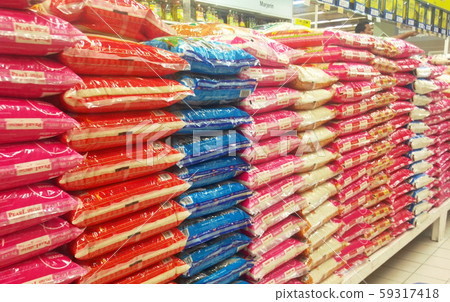 The rice in the plastic packaging is stacked inside the supermarket for sale. Variety of type and price 59317418
