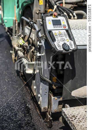Asphalting machine on the road. Asphalting machine on the road. 59318871