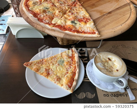 Pizza four cheese and coffee in a white mug in a cafe top view 59320375