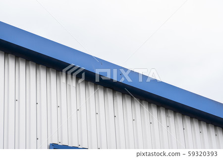 Metal corrugated sheets on a building with a blue metal corners. White aluminium metal corrugated Metal corrugated sheets on a building with a blue metal corners. White aluminium metal corrugated 59320393