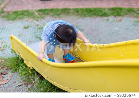 Infants playing in the park 59320674