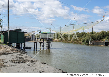 Fishing houses in dock and fishnet. Fishing houses in dock and fishnet. 59320772