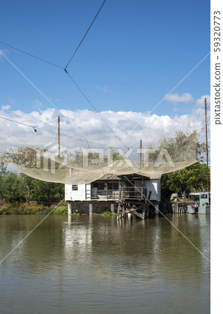 Fishing houses in dock and fishnet. 59320773