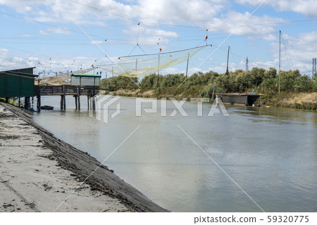 Fishing houses in dock and fishnet. 59320775