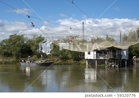 Fishing houses in dock and fishnet. 59320776