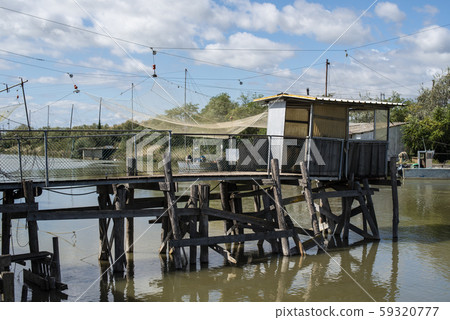 Fishing houses in dock and fishnet. 59320777