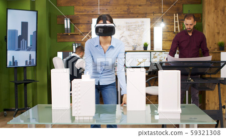 Female architects exploring virtual reality project of business buildings Female architects exploring virtual reality project of business buildings 59321308
