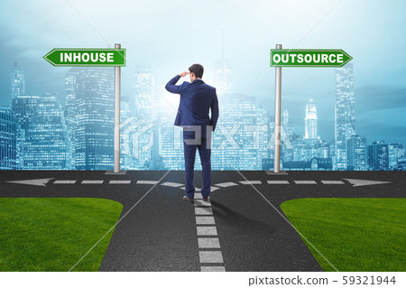 Businessman at crossroads deciding between outsourcing and inhou Businessman at crossroads deciding between outsourcing and inhou 59321944
