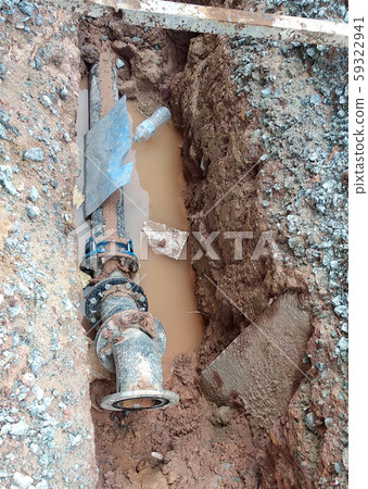 Underground utility and services pipe laid by workers in the trenches at the construction site. Installation of pipes still ongoing.    59322941