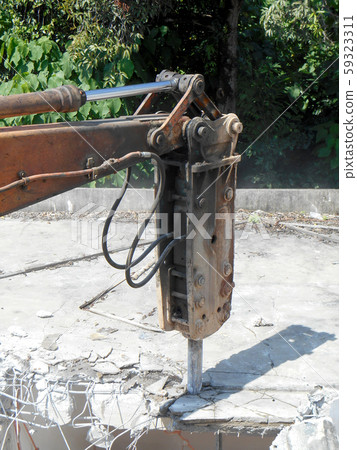 Concrete hacking heavy machine used to crush concrete to small pieces at the construction site in Malaysia.  59323311