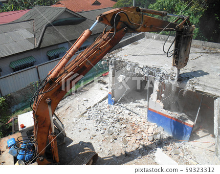 Concrete hacking heavy machine used to crush concrete to small pieces at the construction site in Malaysia. Concrete hacking heavy machine used to crush concrete to small pieces at the construction site in Malaysia. 59323312