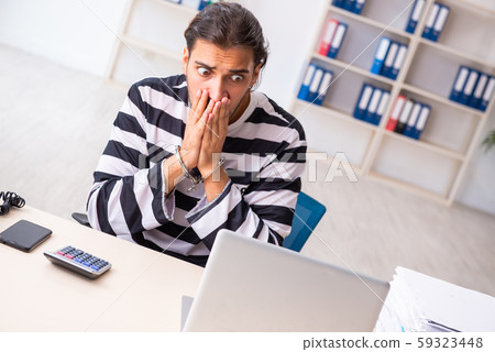Young employee feeling like prisoner at work Young employee feeling like prisoner at work 59323448