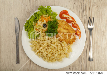 Pasta with a piece of grilled meat and salad. 59323689