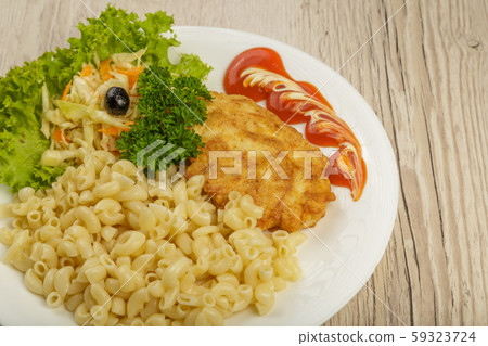 Pasta with a piece of grilled meat and salad. 59323724