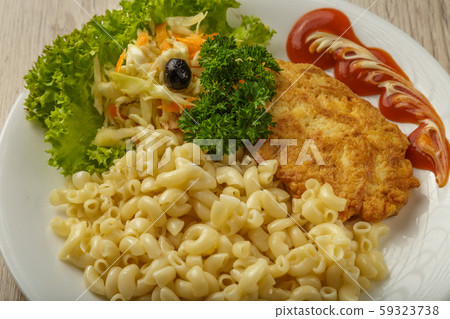 Pasta with a piece of grilled meat and salad. 59323738