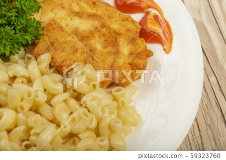 Pasta with a piece of grilled meat and salad. 59323760