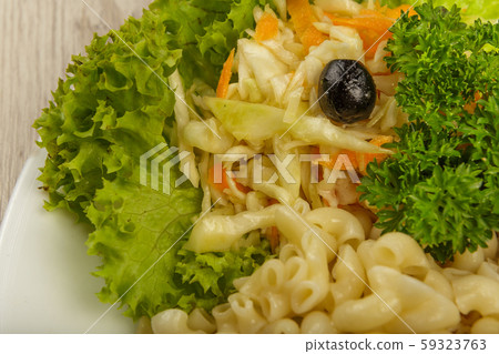 Pasta with a piece of grilled meat and salad. 59323763