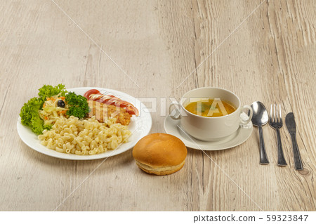 A lunch with a pasta chop with pasta and a roll. 59323847