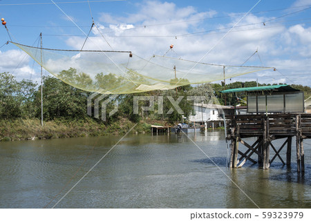 Fishing houses in dock and fishnet. Fishing houses in dock and fishnet. 59323979