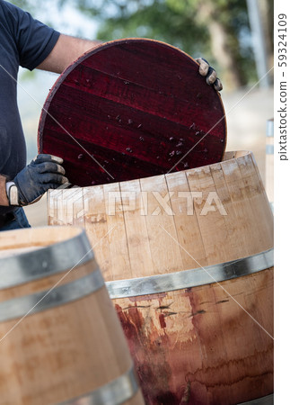 Wine mixing during fermentation process in barrel, Bordeaux Vineyard 59324109