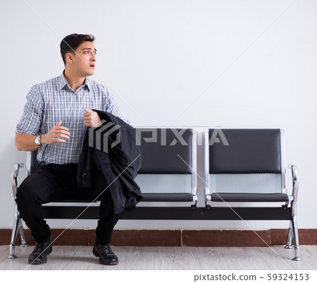 Man nervously impatiently waiting in the lobby 59324153