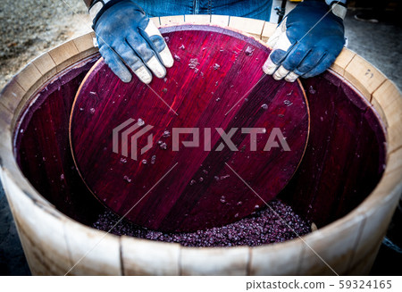 Wine mixing during fermentation process in barrel, Bordeaux Vineyard Wine mixing during fermentation process in barrel, Bordeaux Vineyard 59324165