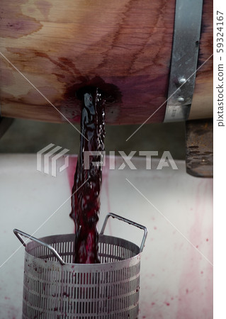 Wine mixing during fermentation process in barrel, Bordeaux Vineyard Wine mixing during fermentation process in barrel, Bordeaux Vineyard 59324167